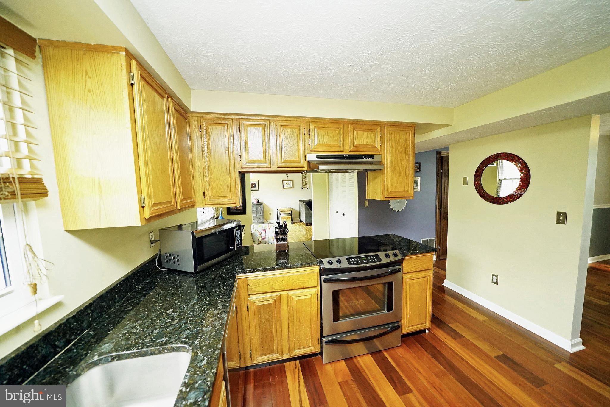 4424 Cub Run Road Chantilly, VA 20151 - Photo 14 of 30 a kitchen with stainless steel appliances a stove a sink and cabinets