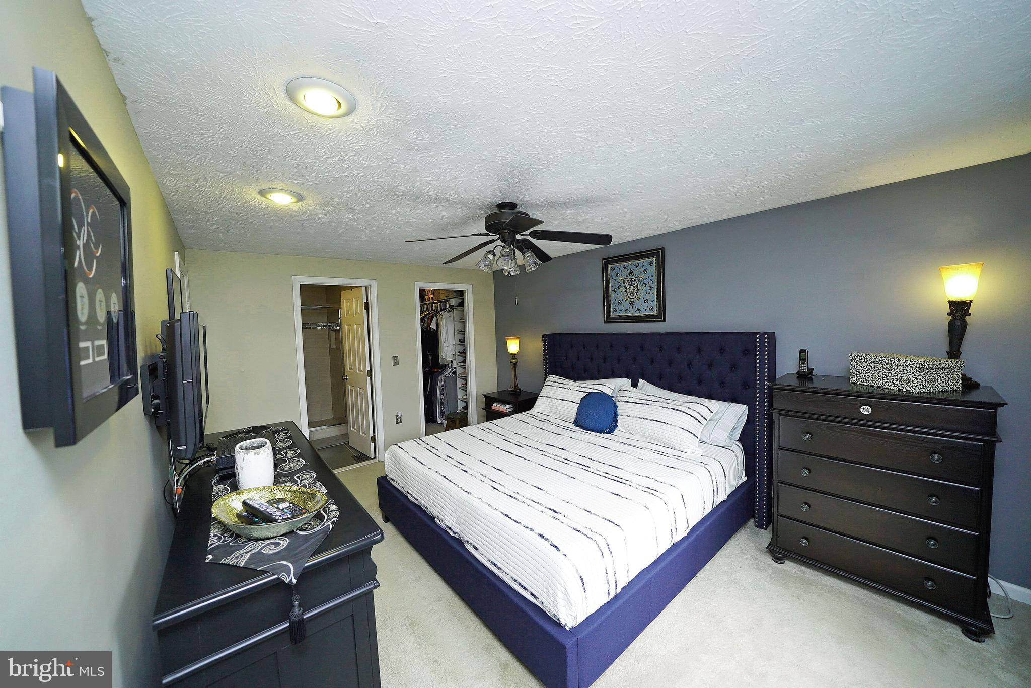 4424 Cub Run Road Chantilly, VA 20151 - Photo 22 of 30 a bedroom with a bed and a chandelier