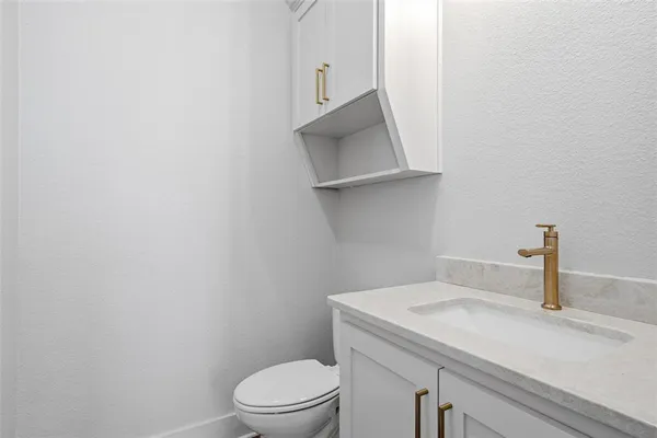 a bathroom with a sink a toilet and mirror