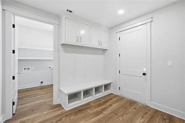 a view of an empty room with wooden floor