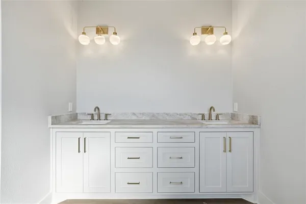 a bathroom with cabinets a sink and dishwasher