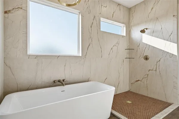 a bathroom with a bathtub and shower