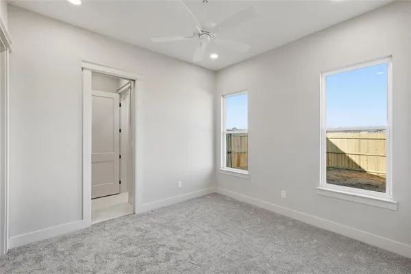 an empty room with windows and closet