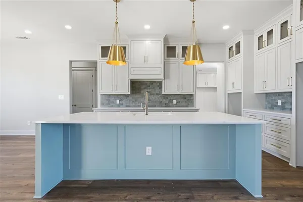 a kitchen with stainless steel appliances granite countertop a sink a stove and a refrigerator