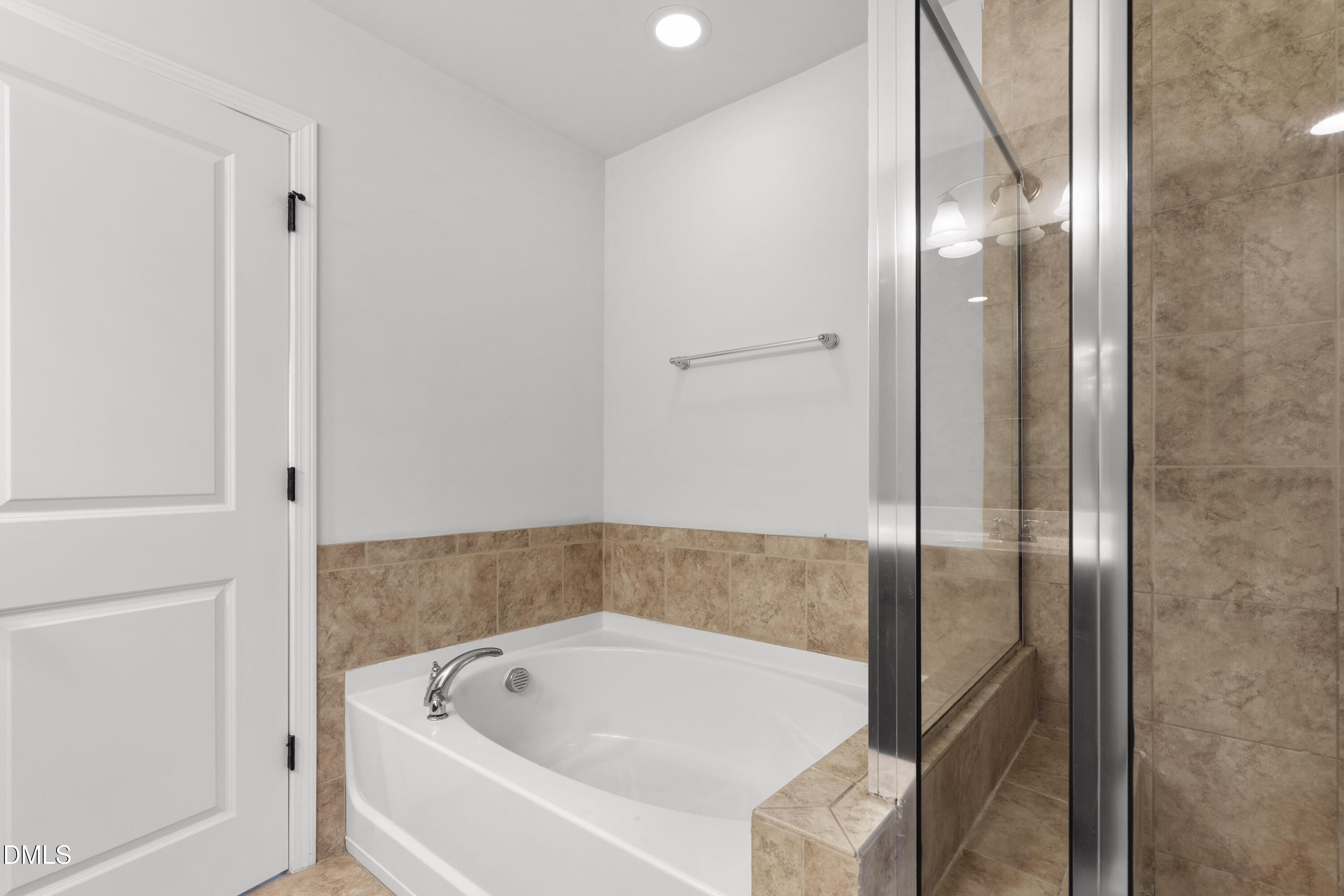 1109 Laurel Twist Road Cary, NC 27513 - Photo 25 of 37 a bathroom with a tub and shower