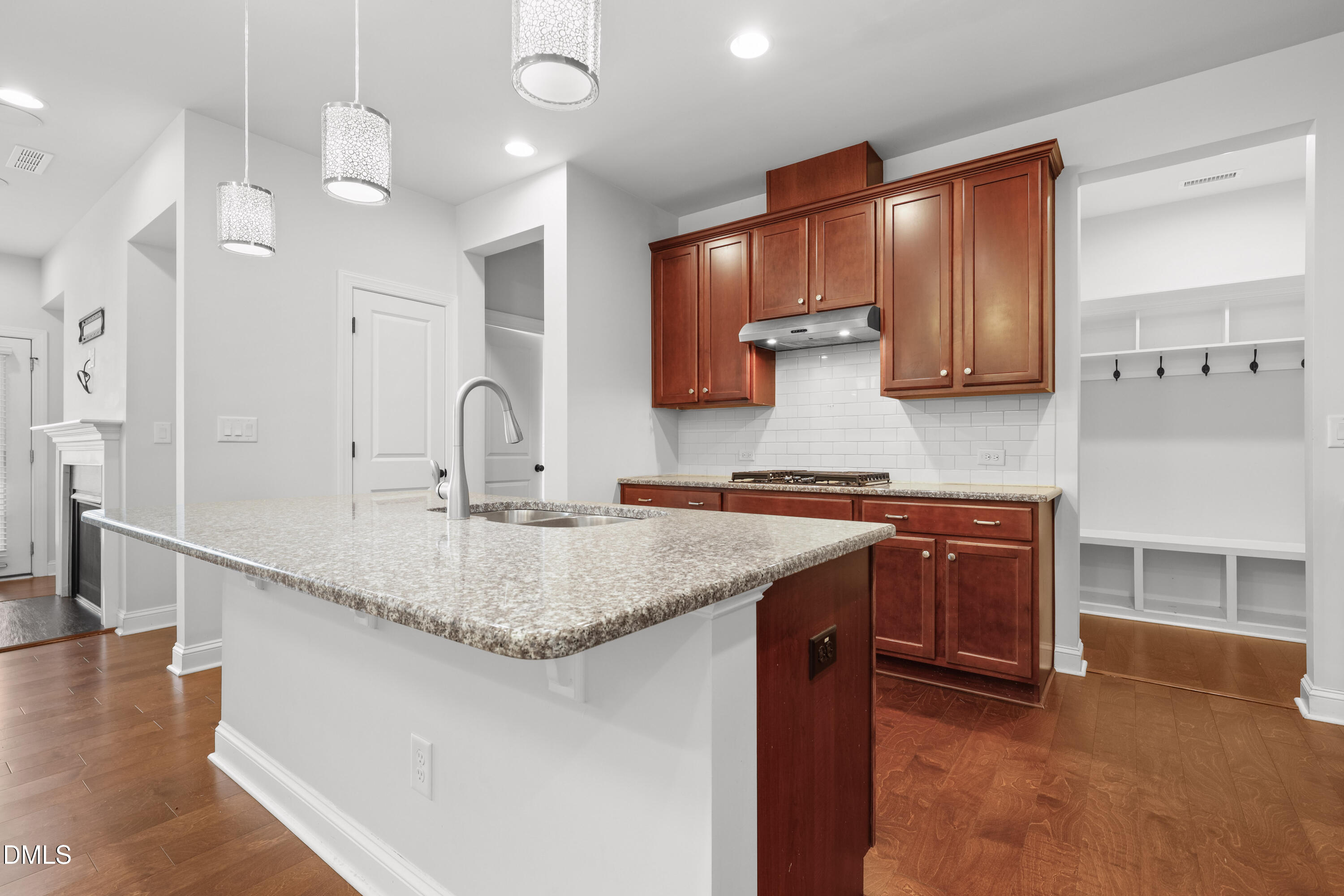 1109 Laurel Twist Road Cary, NC 27513 - Photo 3 of 37 a kitchen with stainless steel appliances granite countertop a sink a stove and a wooden cabinets