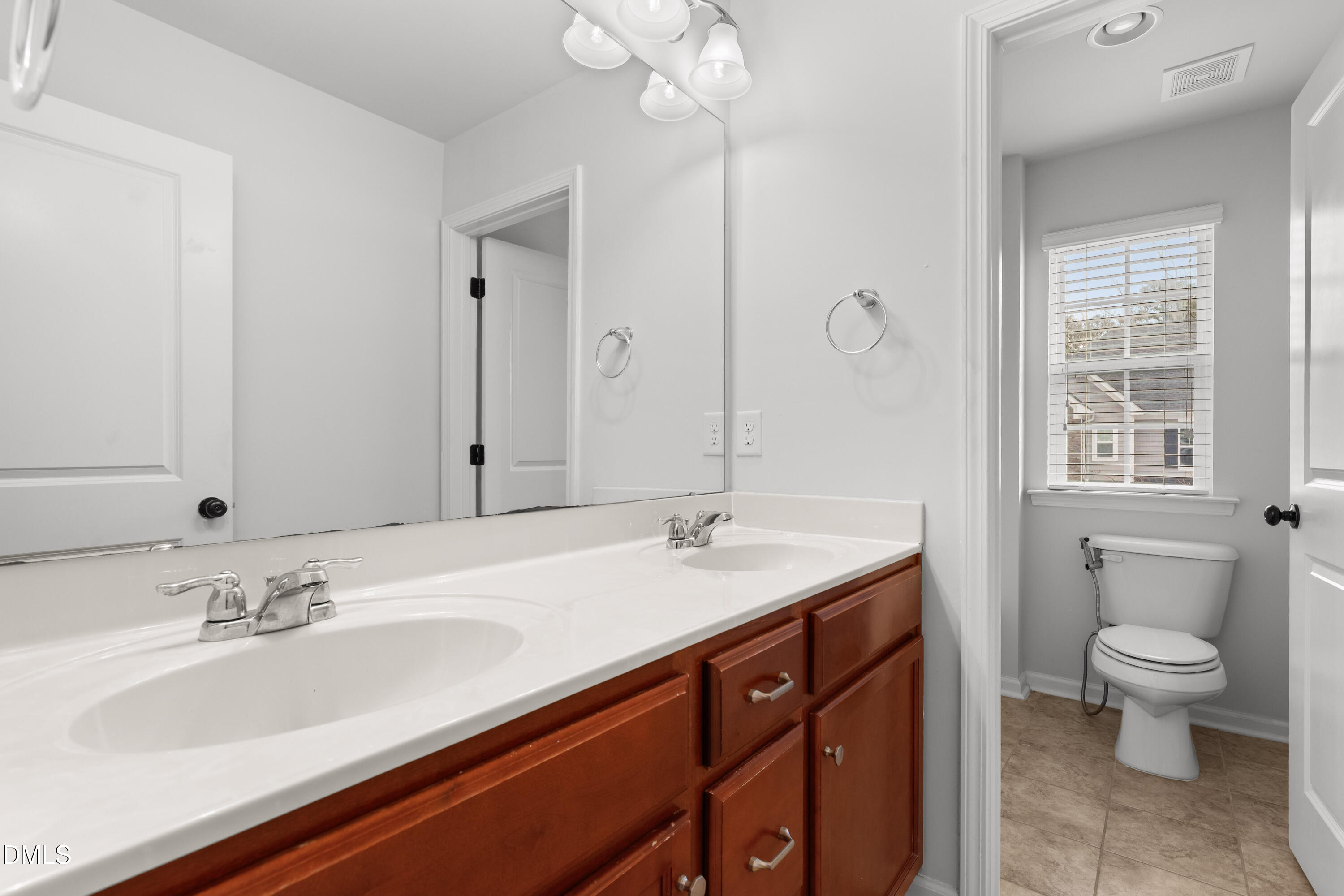 1109 Laurel Twist Road Cary, NC 27513 - Photo 31 of 37 a bathroom with a sink double vanity and a toilet