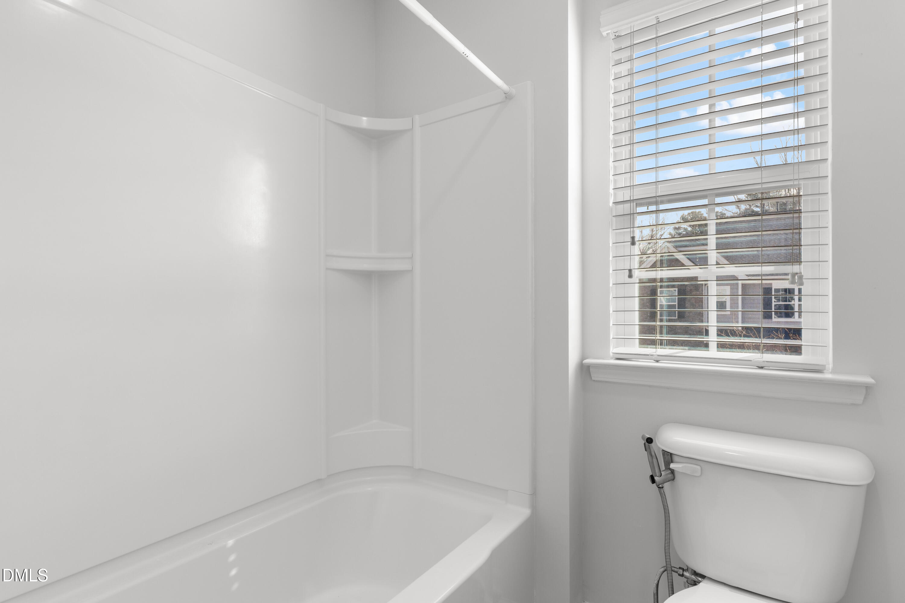 1109 Laurel Twist Road Cary, NC 27513 - Photo 32 of 37 a bath room with a toilet and a bath tub