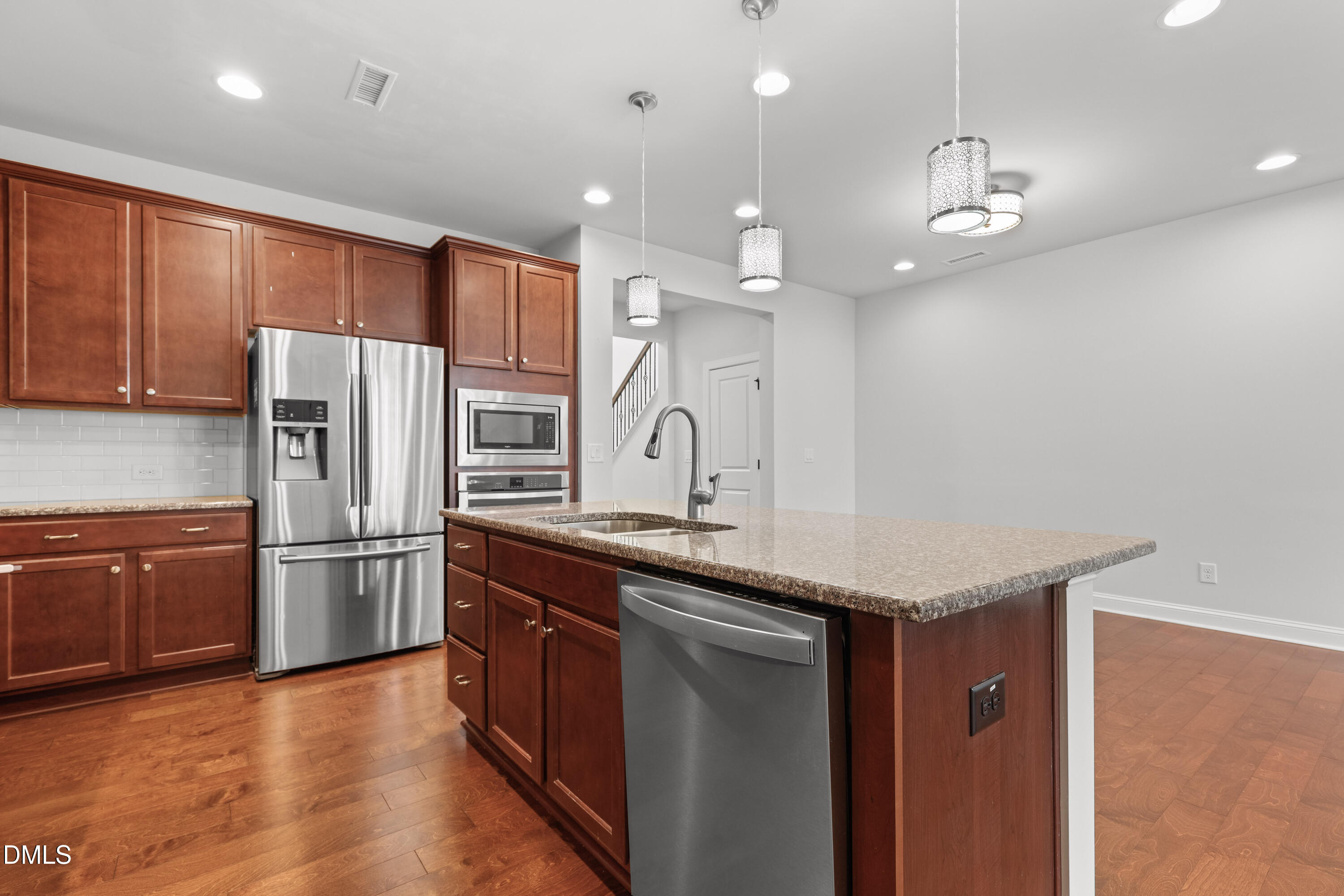 1109 Laurel Twist Road Cary, NC 27513 - Photo 8 of 37 a kitchen with stainless steel appliances granite countertop a sink refrigerator and microwave