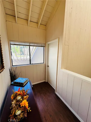 view of hallway with wooden floor and door