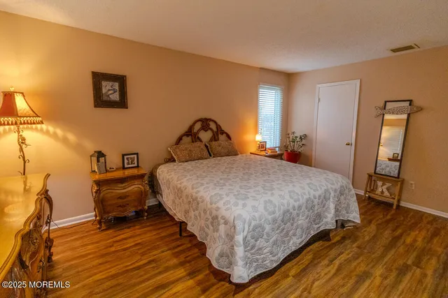 a bedroom with a bed a table and chair