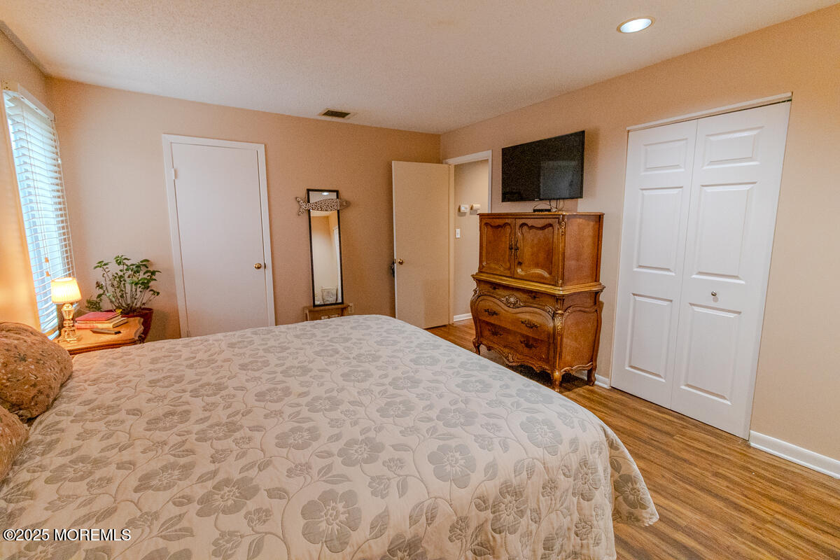 8 Hidden Harbor Drive Point Pleasant, NJ 08742 - Photo 15 of 32 a bedroom with a bed and a flat screen tv