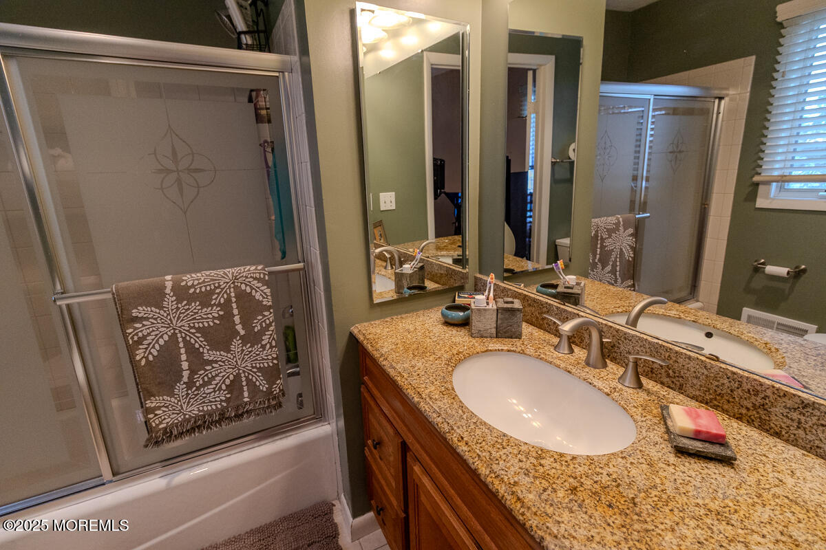 8 Hidden Harbor Drive Point Pleasant, NJ 08742 - Photo 16 of 32 a bathroom with a granite countertop tub sink and mirror