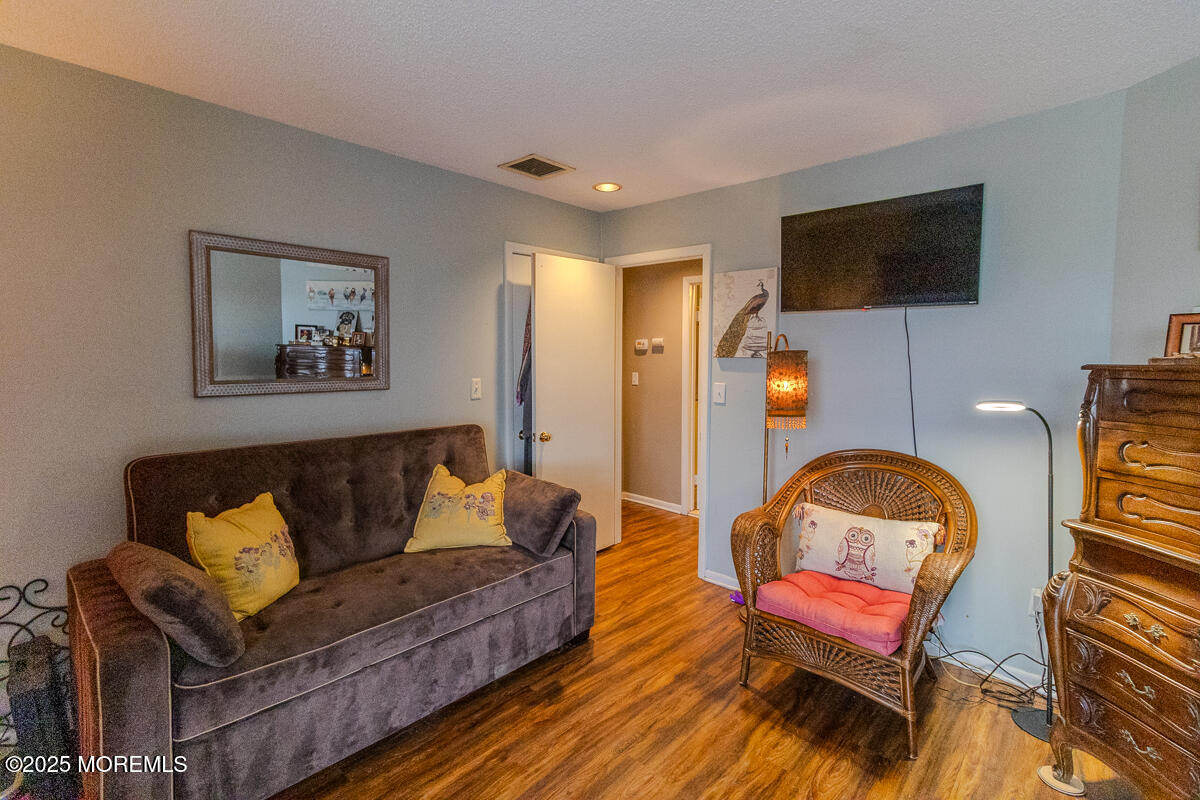 8 Hidden Harbor Drive Point Pleasant, NJ 08742 - Photo 18 of 32 a living room with furniture and a flat screen tv
