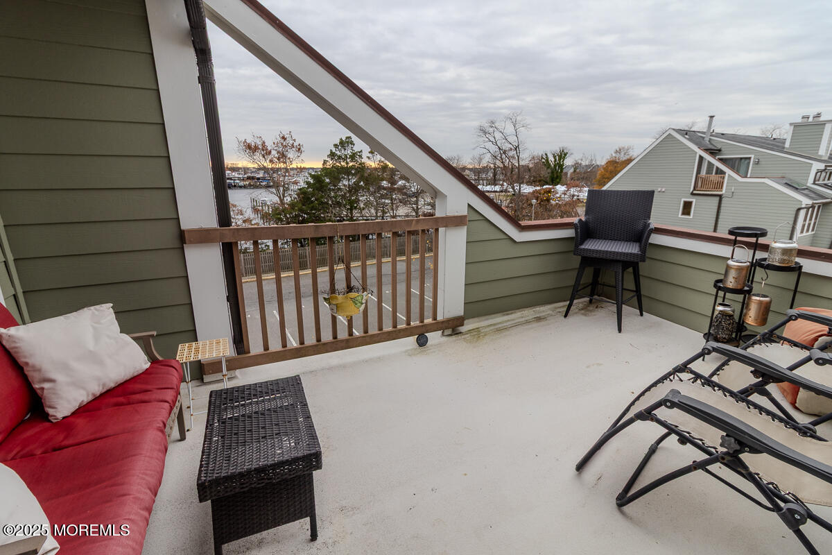8 Hidden Harbor Drive Point Pleasant, NJ 08742 - Photo 22 of 32 a balcony with hardwood filled with table and chairs
