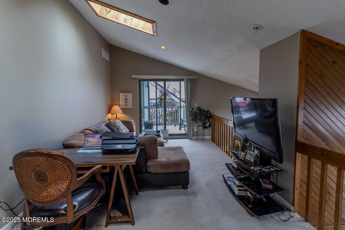 8 Hidden Harbor Drive Point Pleasant, NJ 08742 - Photo 27 of 32 a living room with furniture and a wooden floor
