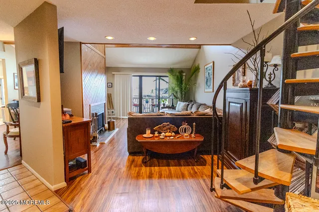 a view of a hallway with wooden floor and furniture