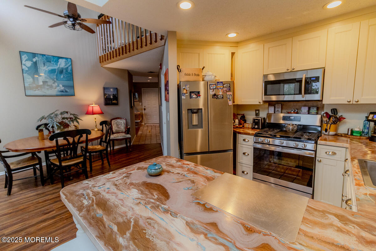 8 Hidden Harbor Drive Point Pleasant, NJ 08742 - Photo 10 of 32 a kitchen with stainless steel appliances kitchen island granite countertop a refrigerator and a stove top oven