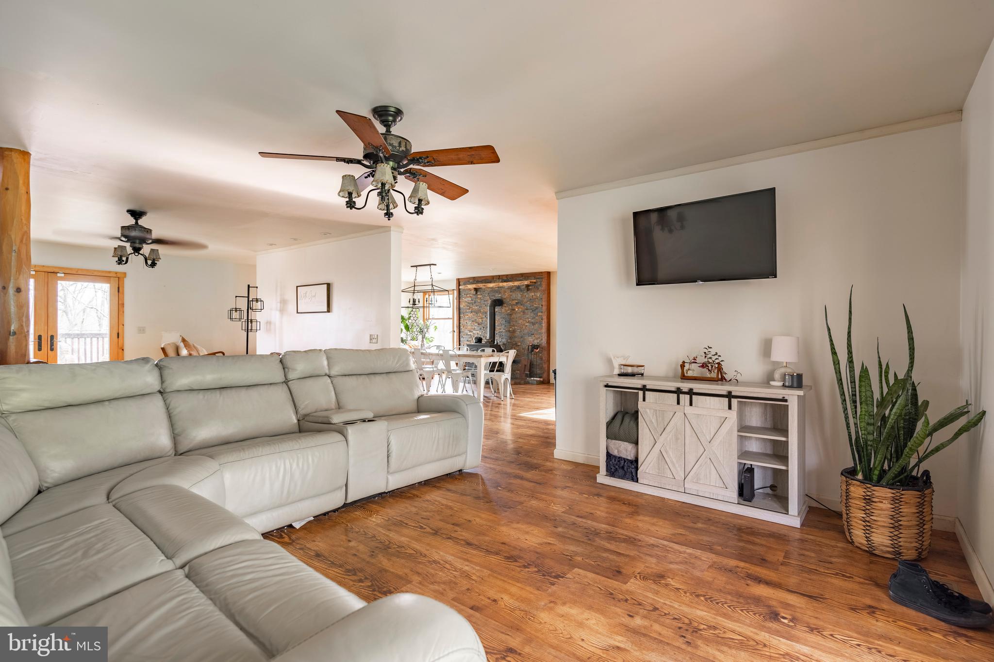755 Sportsman Road Denver, PA 17517 - Photo 33 of 77 a living room with furniture a flat screen tv and a fireplace