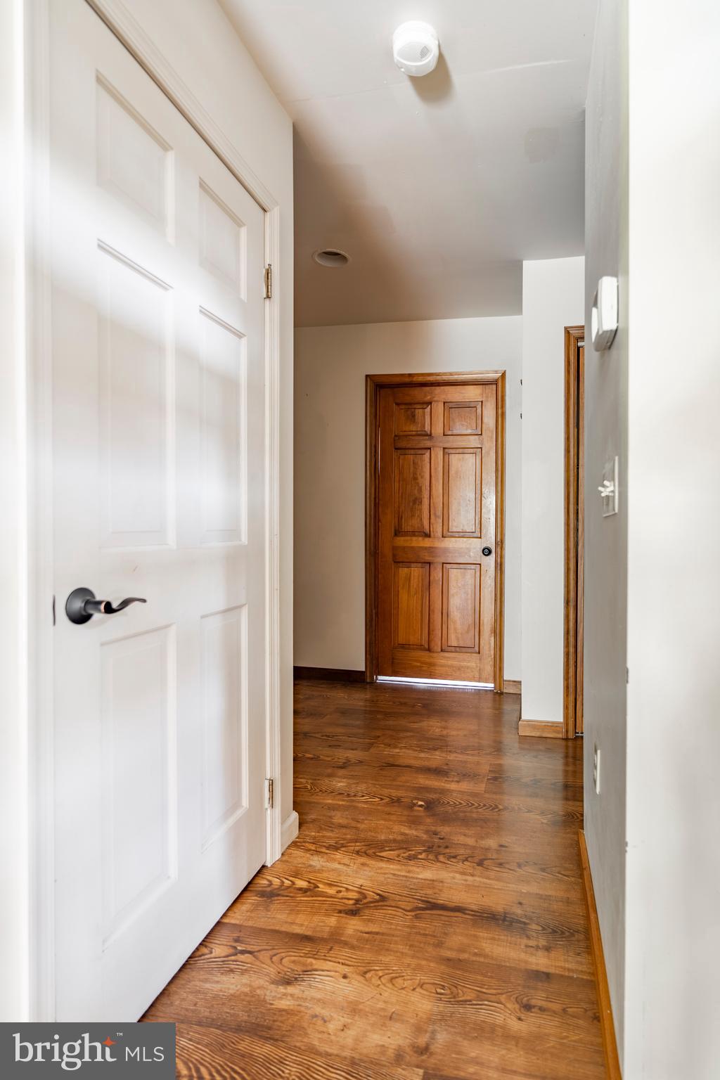 755 Sportsman Road Denver, PA 17517 - Photo 45 of 77 a view of an empty room with wooden floor and a door