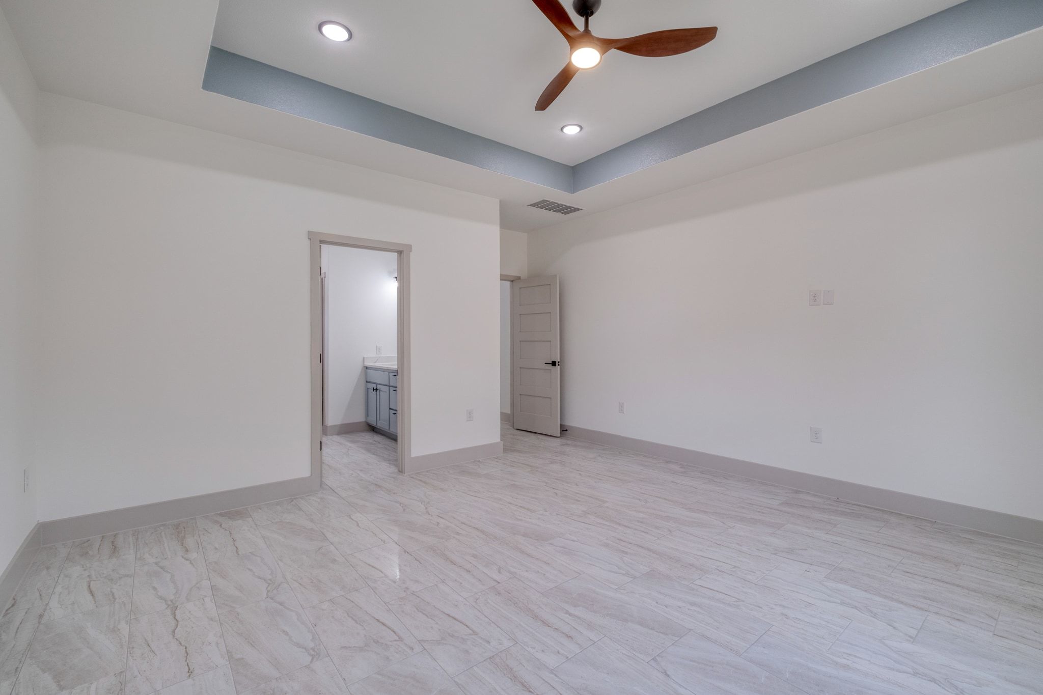 202 Washington Street Elgin, TX 78621 - Photo 13 of 26 Primary room with a raised ceiling, recessed lighting, and a ceiling fan