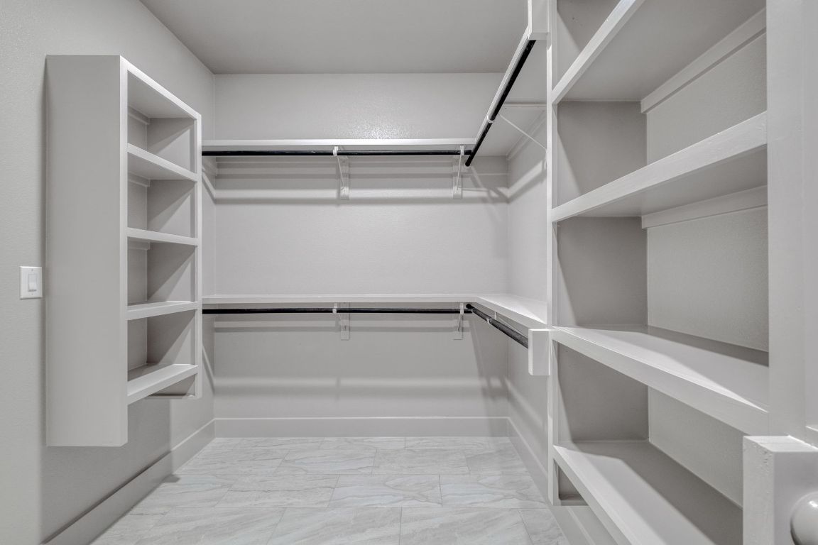 202 Washington Street Elgin, TX 78621 - Photo 17 of 26 Walk in closet featuring light marble finish floors