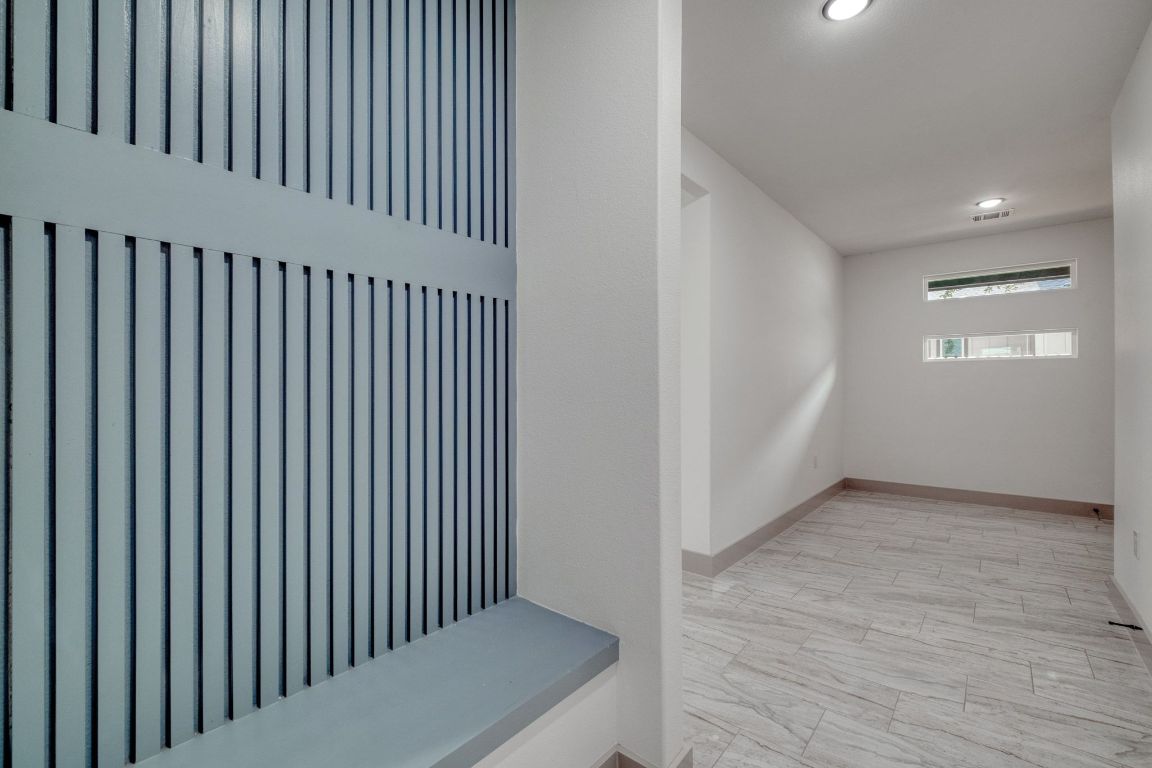 202 Washington Street Elgin, TX 78621 - Photo 22 of 26 Are right in front of Garage entrance with built in bench and decorative wall