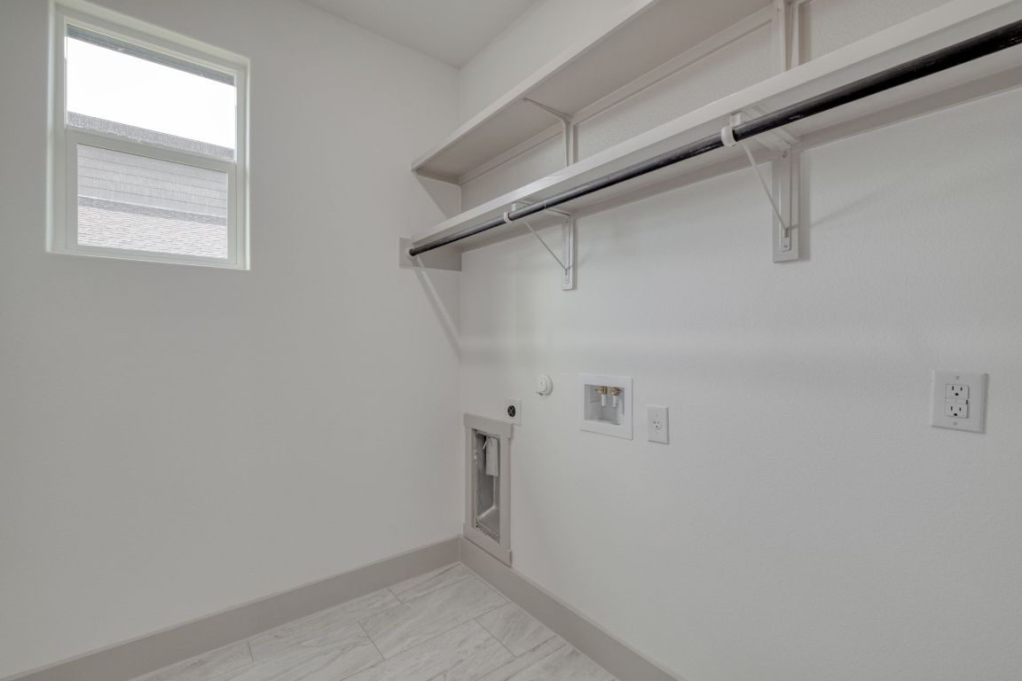 202 Washington Street Elgin, TX 78621 - Photo 23 of 26 Laundry room with hookup for a gas dryer, washer hookup, and hookup for an electric dryer