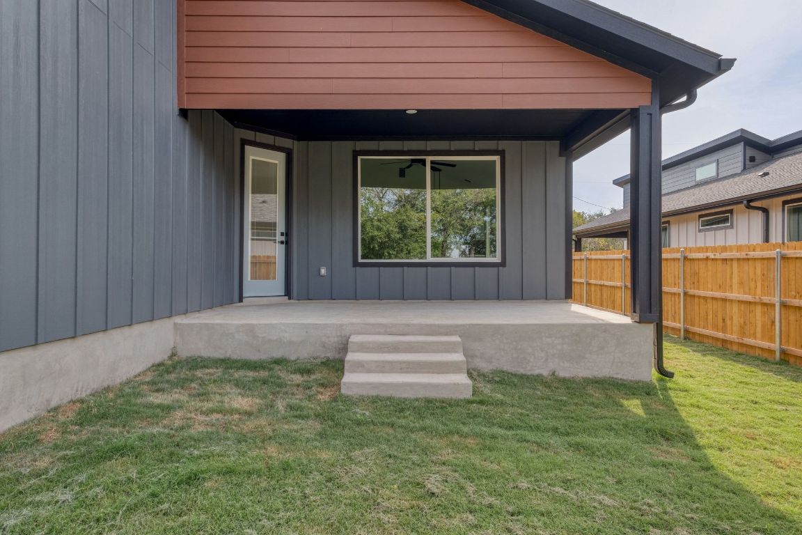 202 Washington Street Elgin, TX 78621 - Photo 25 of 26 Property entrance with board and batten siding, a patio area, and a ceiling fan
