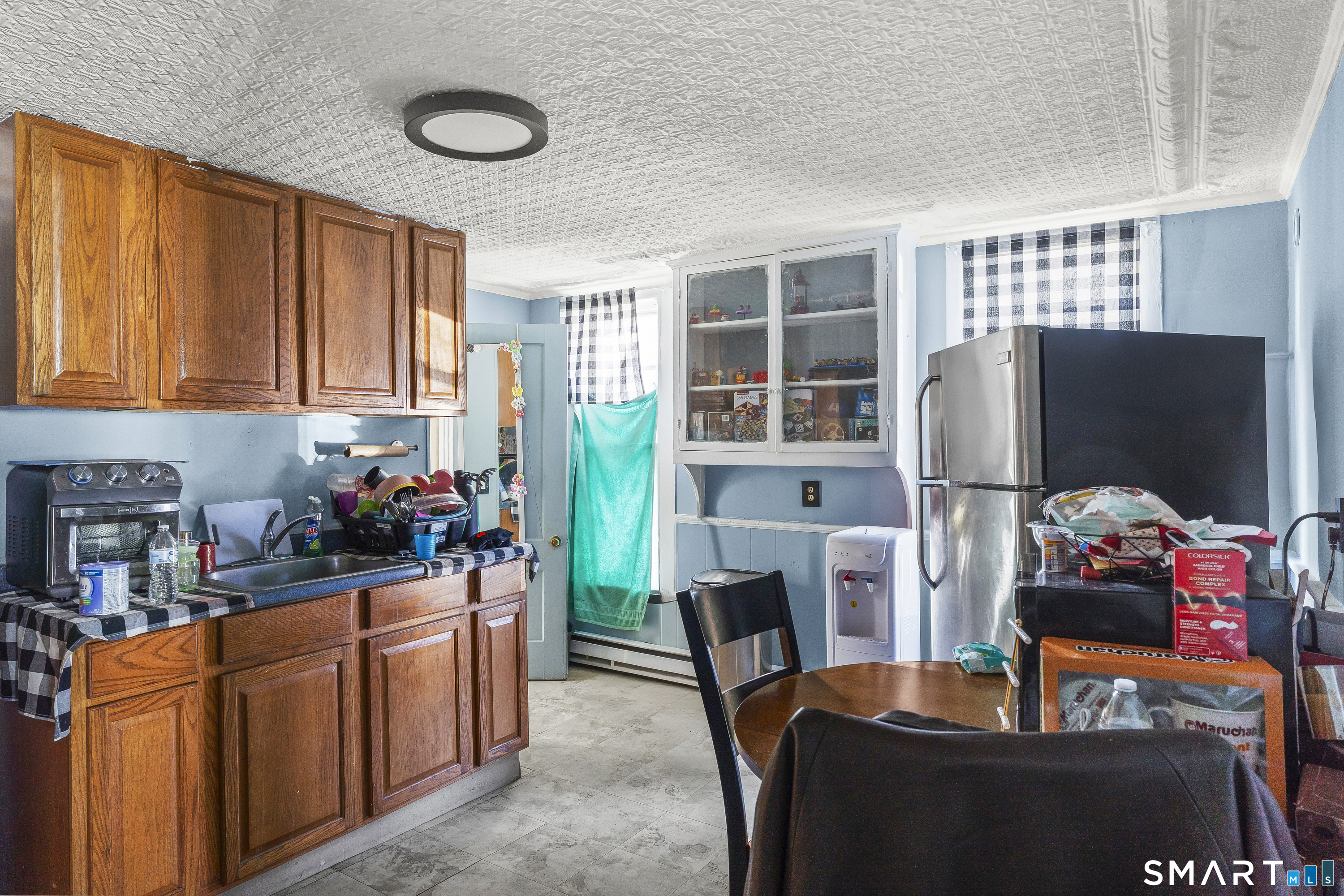 160 Springdale Avenue Meriden, CT 06451 - Photo 12 of 19 a room with furniture a flat screen tv and a refrigerator