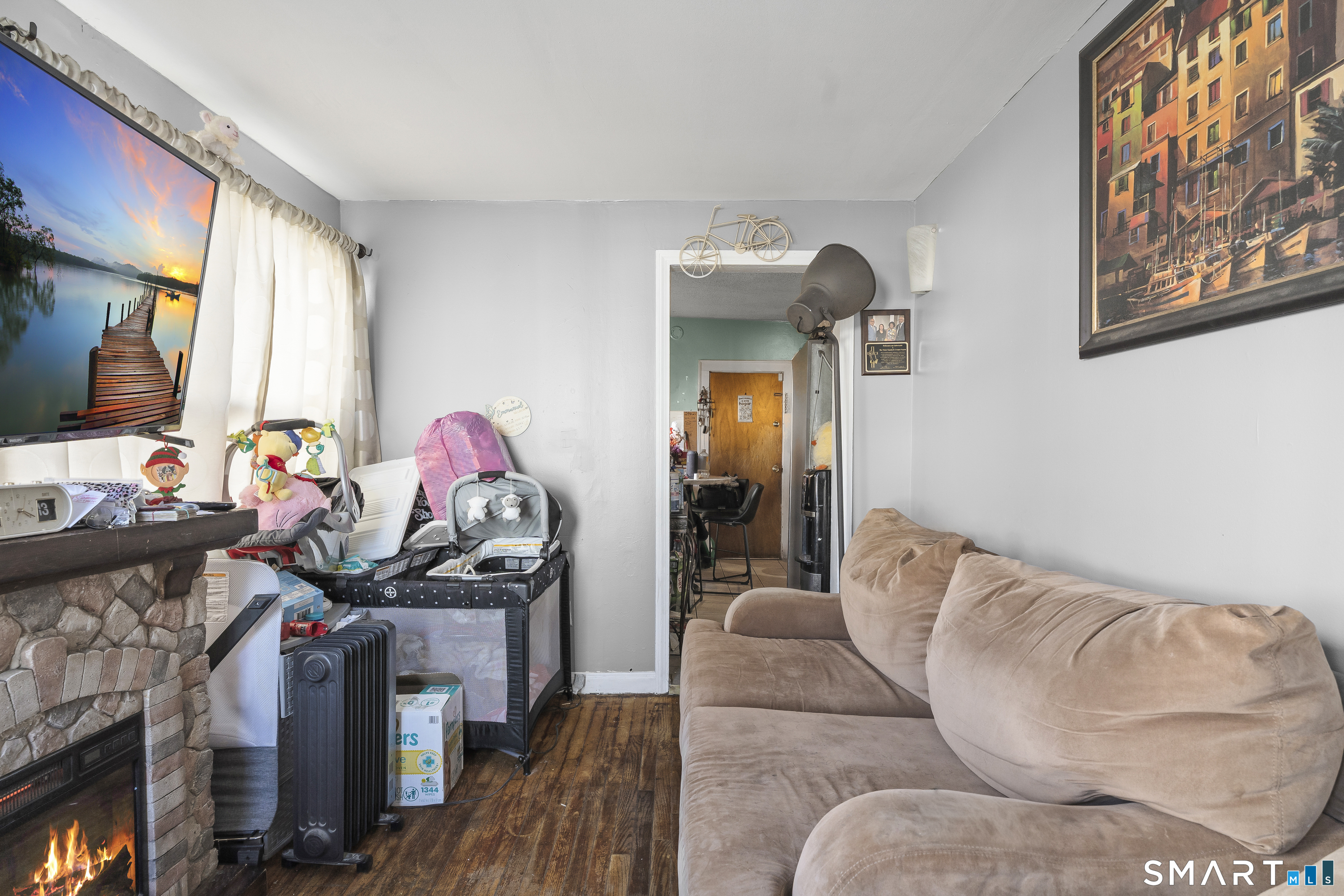 160 Springdale Avenue Meriden, CT 06451 - Photo 6 of 19 a living room with furniture a flat screen tv and a floor to ceiling window