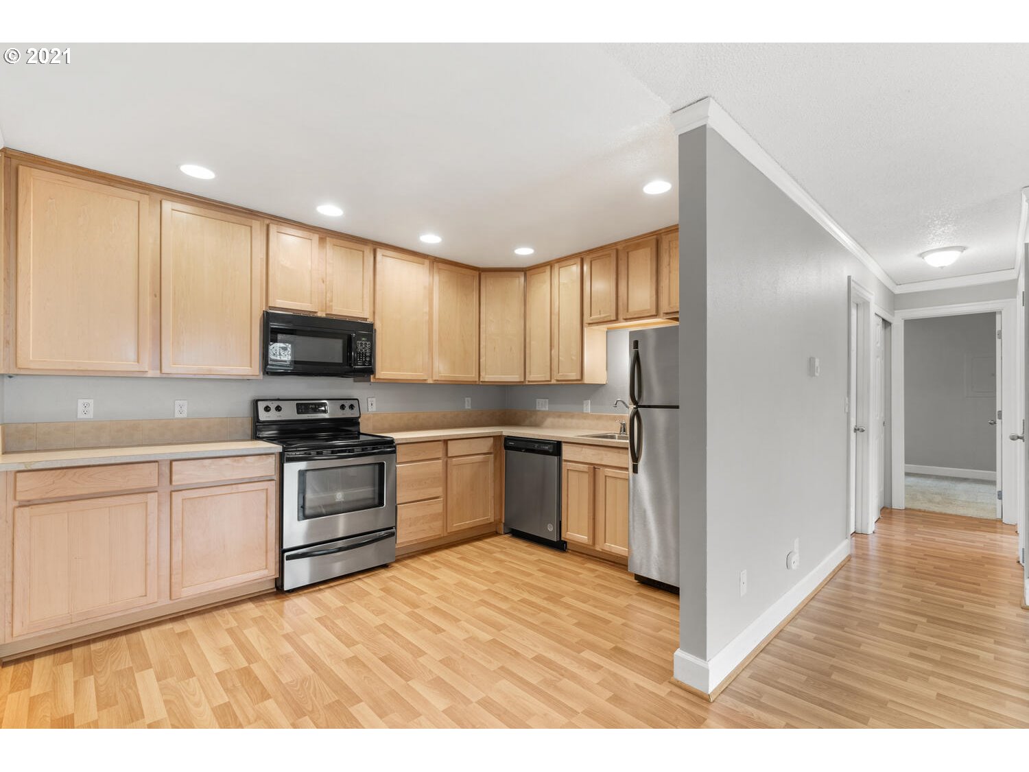 8065 North Ivanhoe Street, Unit 5 Portland, OR 97203 - Photo 12 of 32 a kitchen with granite countertop a refrigerator stove top oven and sink