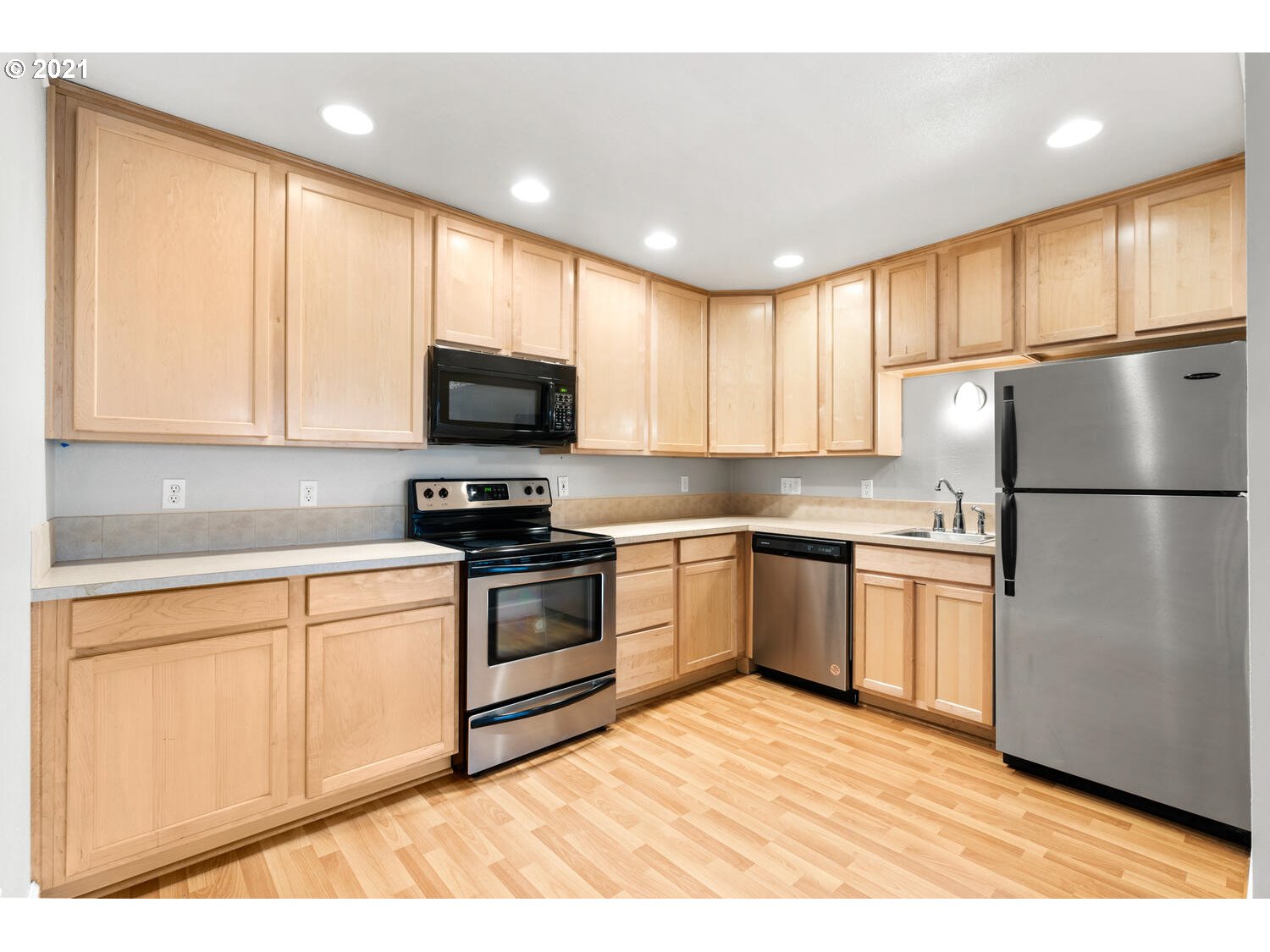 8065 North Ivanhoe Street, Unit 5 Portland, OR 97203 - Photo 13 of 32 a kitchen with a refrigerator stove top oven and cabinets