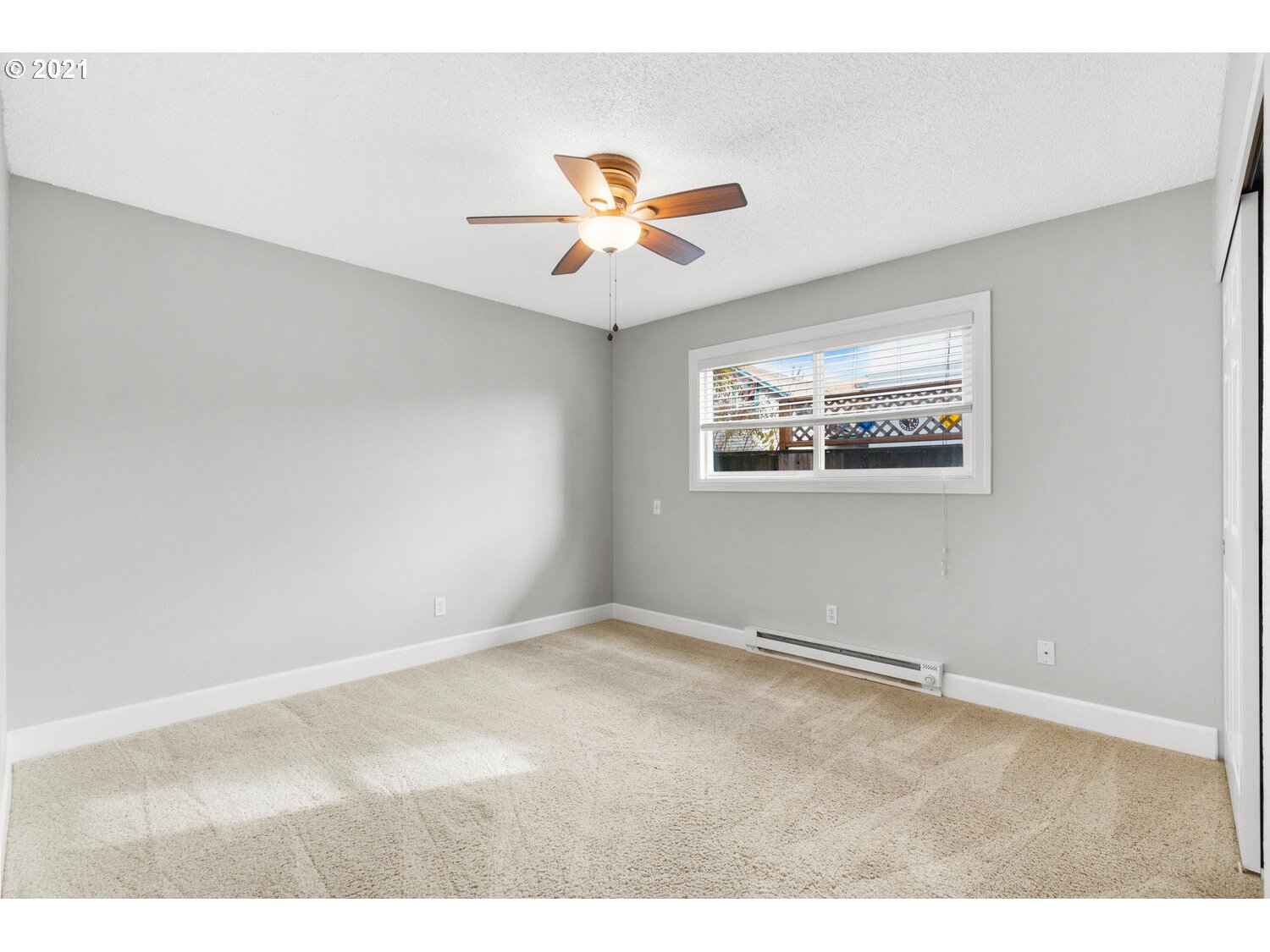 8065 North Ivanhoe Street, Unit 5 Portland, OR 97203 - Photo 14 of 32 an empty room with windows and fan