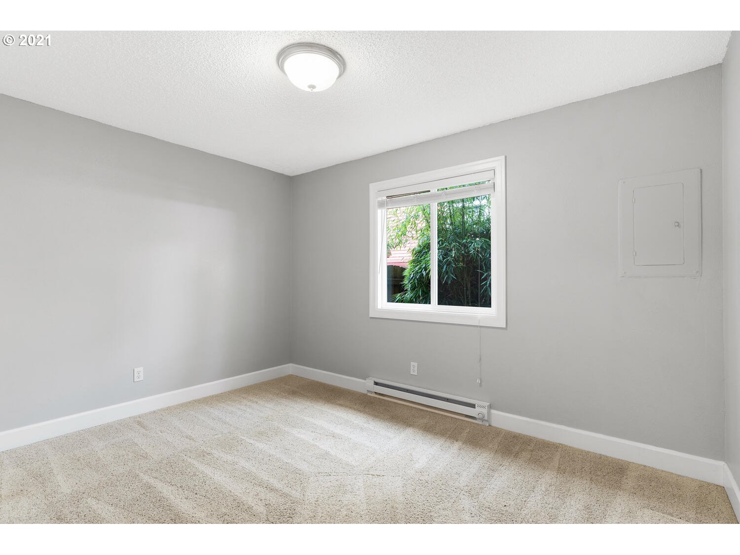 8065 North Ivanhoe Street, Unit 5 Portland, OR 97203 - Photo 16 of 32 an empty room with wooden floor and windows