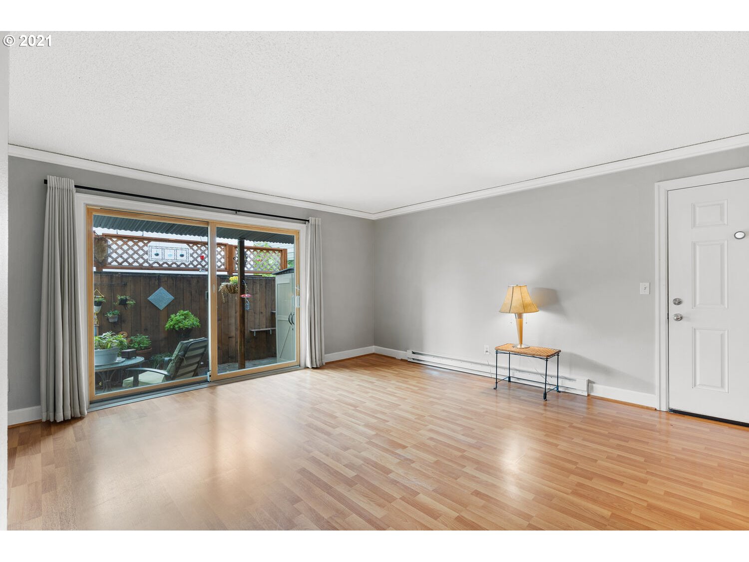8065 North Ivanhoe Street, Unit 5 Portland, OR 97203 - Photo 5 of 32 a view of an empty room with wooden floor and a window
