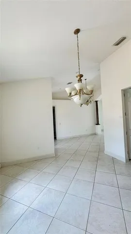 a view of a kitchen with cabinet and a chandelier fan