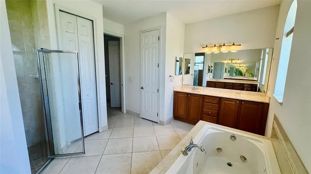 a bathroom with a double vanity sink and mirror