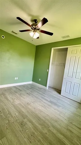 a view of a room with a sink and a ceiling fan