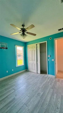 a view of empty room with a ceiling fan and a window
