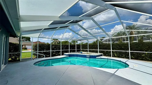 a view of a room with a wooden floor and potted plant