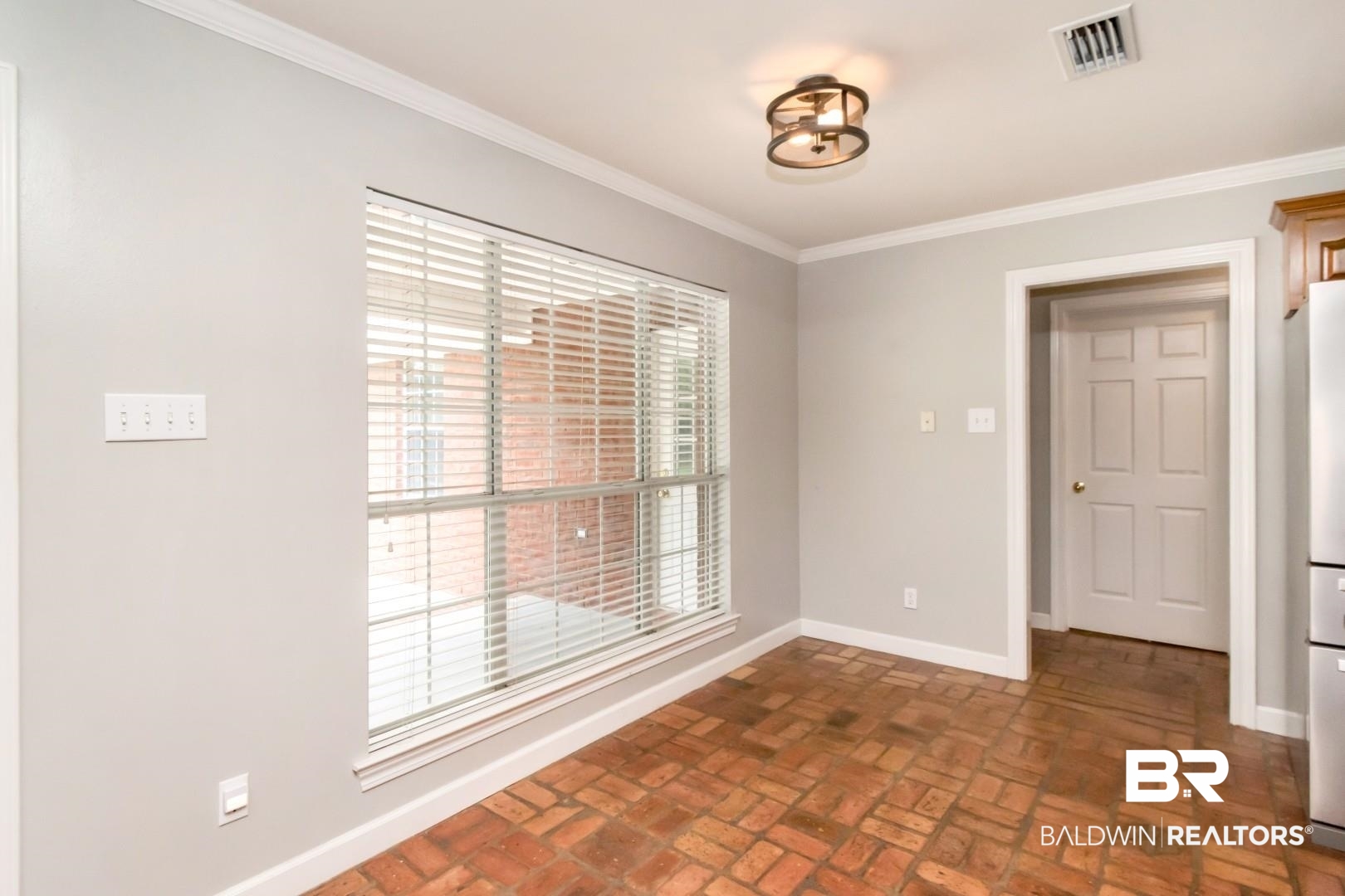 10691 Hunters Ridge Drive Mobile, AL 36695 - Photo 14 of 37 Room featuring brick-finish flooring, a large window with horizontal blinds, and a contemporary flush-mount ceiling light