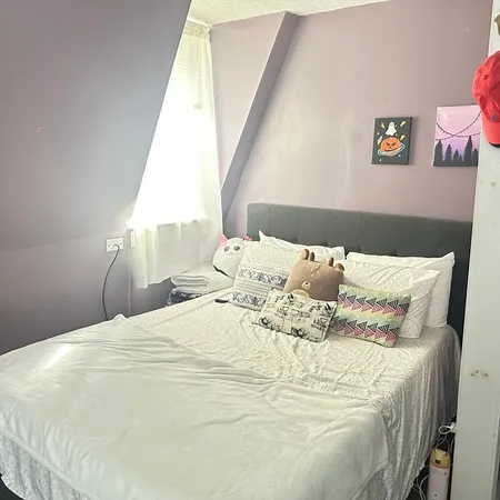 a large white bed in a white room