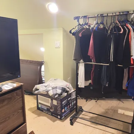 a living room with furniture a flat screen tv and a window