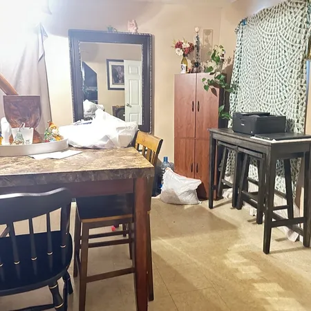 a living room with furniture and a dining table