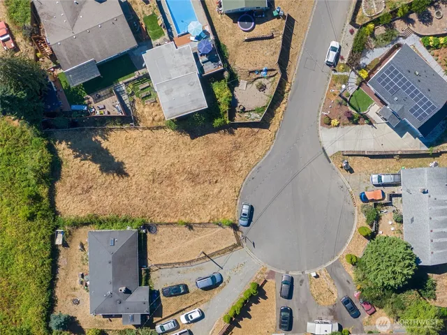 an aerial view of a house with a yard and lake view