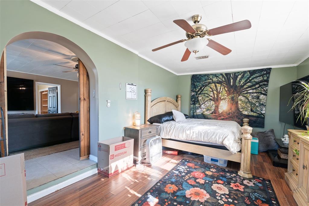 7002 Eisenhower Street Weeki Wachee, FL 34613 - Photo 11 of 65 a bed room with a bed and a chandelier