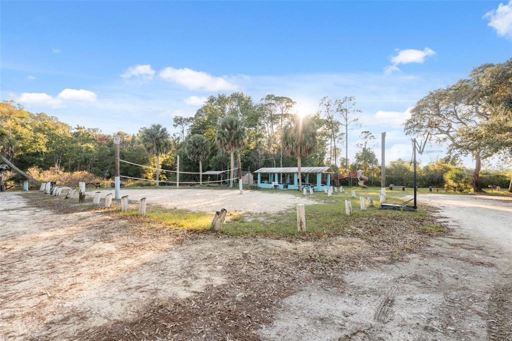 7002 Eisenhower Street Weeki Wachee, FL 34613 - Photo 18 of 65 a view of a park with swings and slides