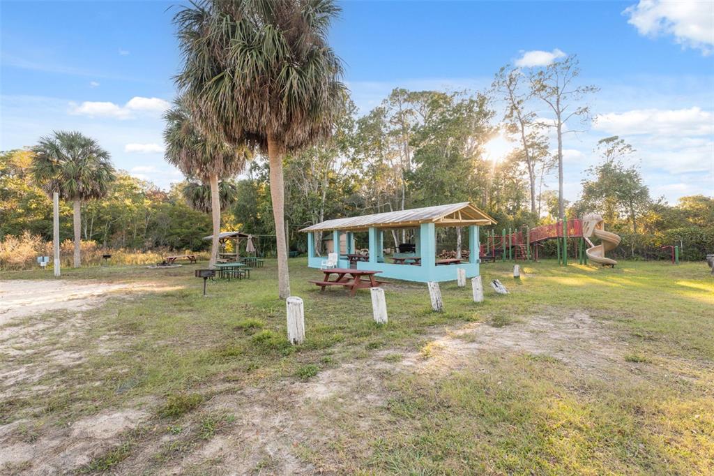 7002 Eisenhower Street Weeki Wachee, FL 34613 - Photo 19 of 65 a house view with swimming pool and sitting space