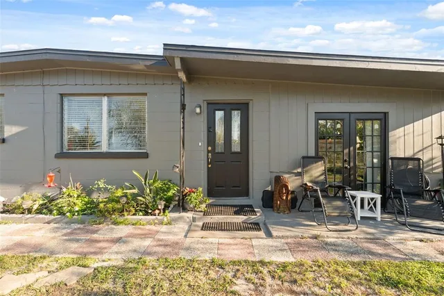 a front view of a house with outdoor seating